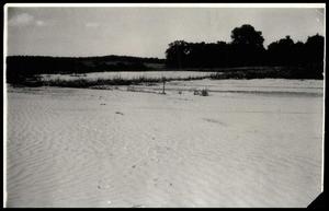 Primary view of object titled 'Damaged Field Covered In Sand'.