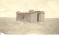 Photograph: Sod house on the prairie. Date and location unknown.