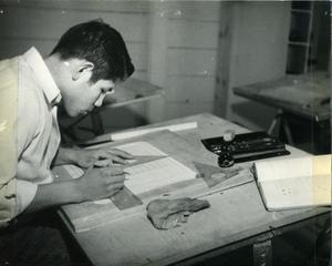 Training Is Offered In Power Plant Operation; Printing. Here Oscar Little Doctor, A Carpentry Student, Prepares Work On The Drafting Board.