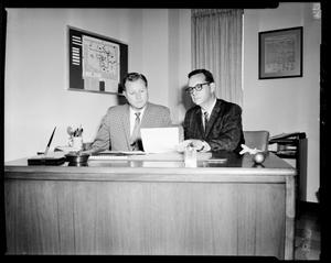 Two Men Seated at a Desk