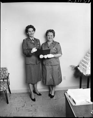 Two Girl Scout Leaders Posing Next to a Cake