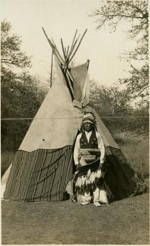 Indian man in front of Teepee