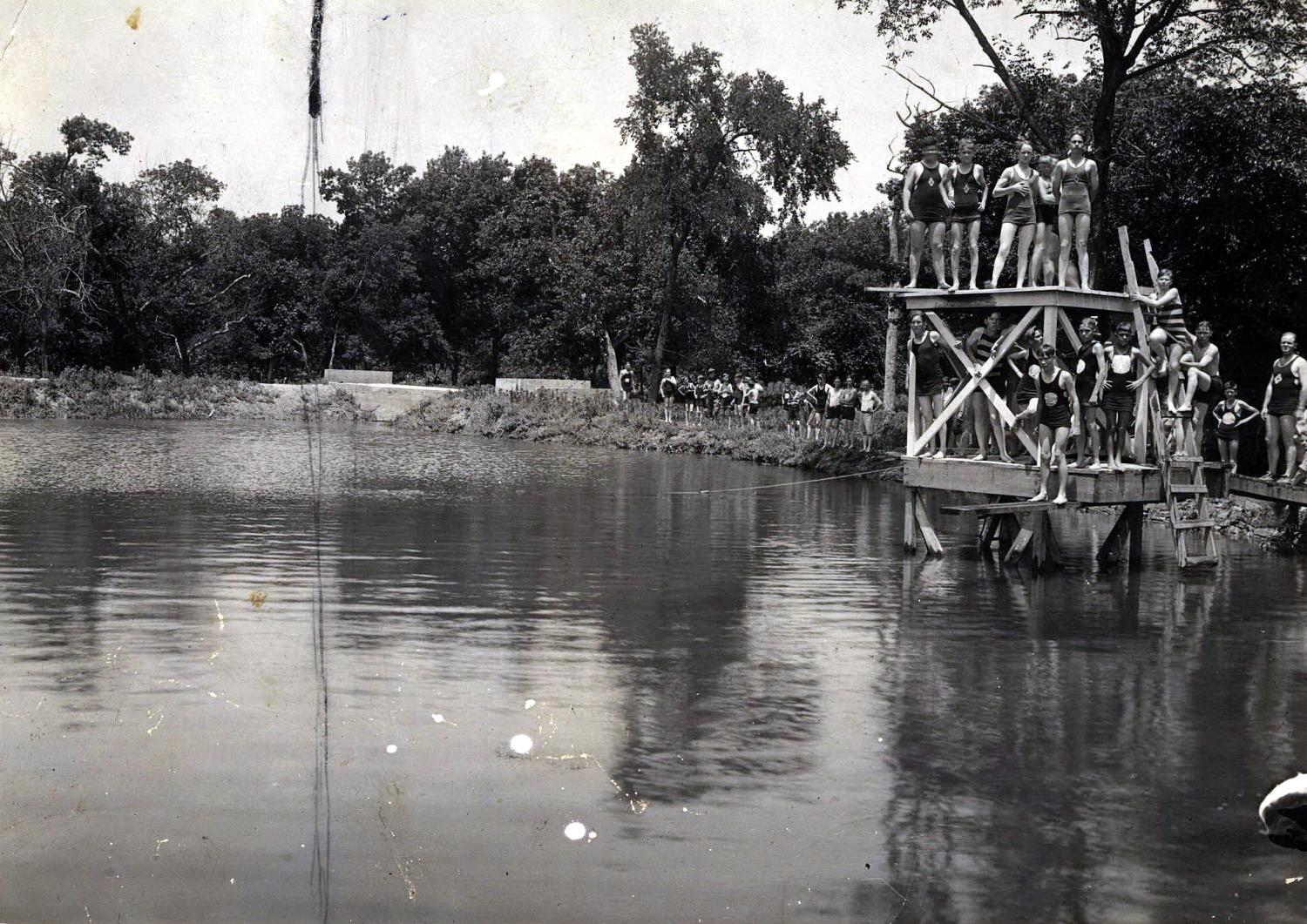 Crowd of boys on the wooden diving platform at Lorena Park north of Ardmore.
                                                
                                                    [Sequence #]: 1 of 1
                                                