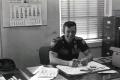 Photograph: A member of the Ardmore Police at a desk in the station.