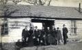 Photograph: The members of the G.B Douglas family pose beside their home in the s…