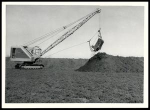 Showing Original Dark Soil Being Dug By Excavator
