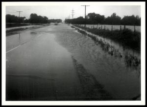 Car Driving on a Partially Flooded Road