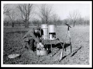 Primary view of object titled 'John Cahoon Conducting an Infiltration Test on Bill Byars Land'.