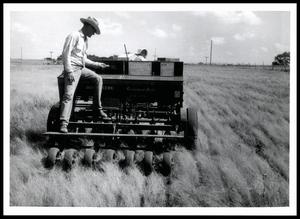 Mr. and Mrs. Bethel Jackson Using a John Deere Grassland Drill to Plant African Weeping Lovegrass, Vetch, and 200 Pounds of 5-10-5 Fertilizer