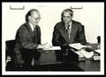 Photograph: Hampton Burns and L. W. “Bad” Johnson Signing A Memorandum