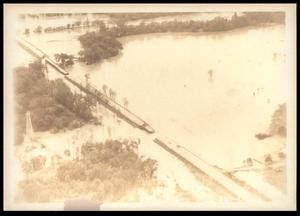 Primary view of object titled 'Damaged Road Spanning A Flooded Wildhorse Creek'.