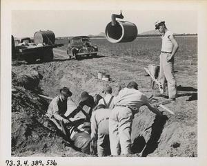 Laborers Laying Pipe