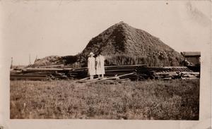 Two Women in Front of the Mud Lodge