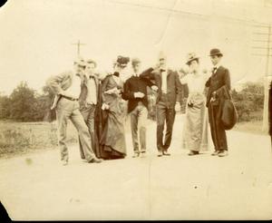 Seven People Posing on a Dirt Road