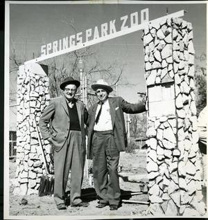 Two Men Standing Under Springs Park Zoo Sign