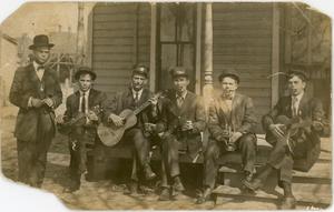 Men Sitting on a Porch Playing Music