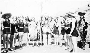Several Women in Swimsuits with a Tribal Chief