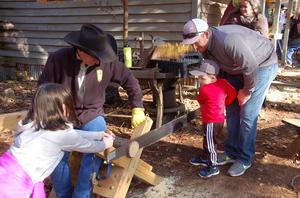Children Learning to Saw Wood
