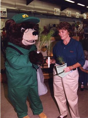 Woman Holding Baby Plants with Tree Bear