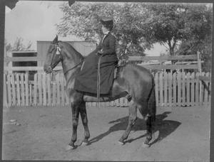 Mrs. George Rainey riding a horse.